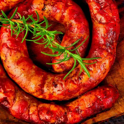 a group of sausages on a wooden surface - Venison Italian Sausage Recipe